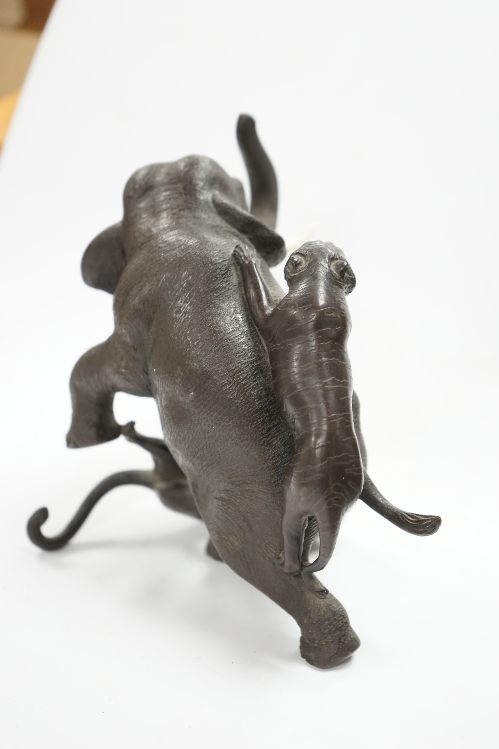 After Genryusai Seiya (1868-1912), a 19th century Japanese Meiji period cast bronze group of an elephant being attacked by tigers, seal mark, 14cm high. CITES Submission reference P5SHZWF1. Condition - good